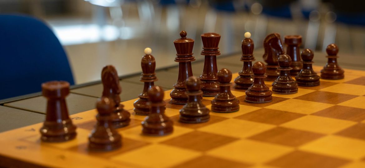 wooden chess pieces on chess board